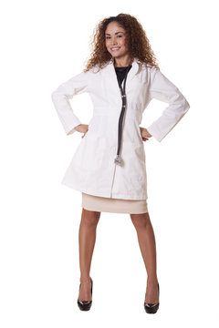 Female Physician smiles while standing like a superhero.