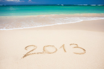 New year background of beach with "2013" handwritten in the sand