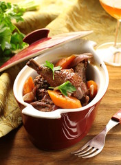 Traditional French cuisine - chicken in wine, coq au vin © Olga Kriger