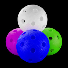 Four floorball balls isolated on a black background