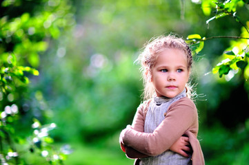 preschooler girl in casual clothes at green nature park backgrou