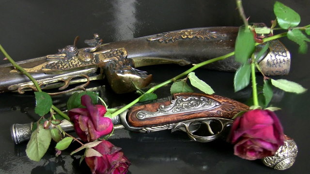 Antique guns and withered roses