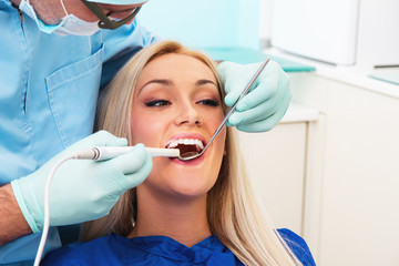 Dentist examines teeth of the patient with teeth-camera