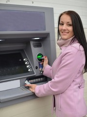 Beautiful woman using ATM