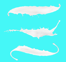 splashing milk isolated on blue background 