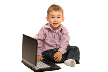 Smiling little boy with laptop