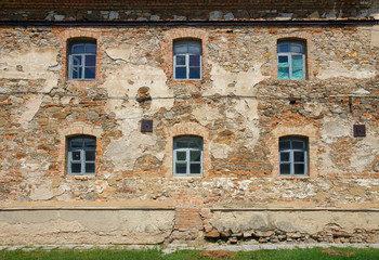 Fototapeta na wymiar Old orange brick wall with six windows