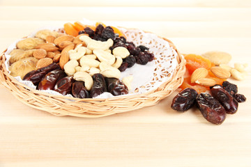 different dried fruits on wooden background