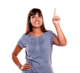 Beautiful young woman pointing and looking up