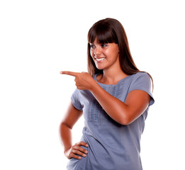 Beautiful young woman pointing and looking right