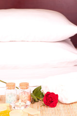 Romantic spa getaway with bath salt and pillows background