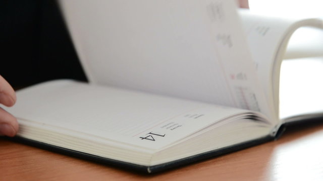Man searches an important note in a notebook. Full HD