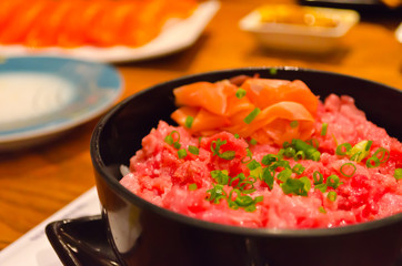 Toro Donburi in the black bowl.