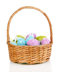 Colorful easter eggs in basket isolated on white