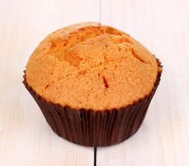 Fresh muffin on wooden background