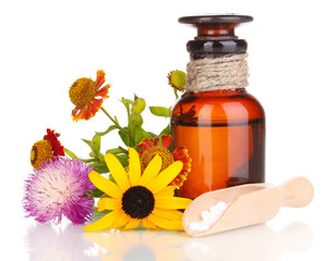 medicine bottle with tablets and flowers isolated on white