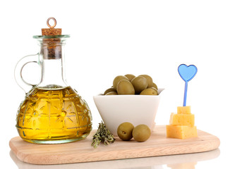 Green olives in white bowl with rosemary,olive oil and cheese