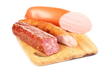 Tasty sausage on chopping board isolated on white