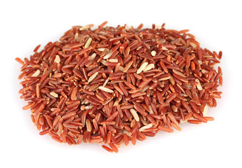 red  rice uncooked in a heap isolated on a white background