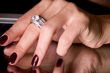 Hand with golden jewelry on black background