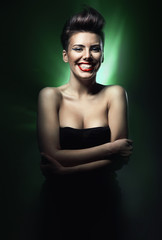 smiling brunette woman with red lips in green light