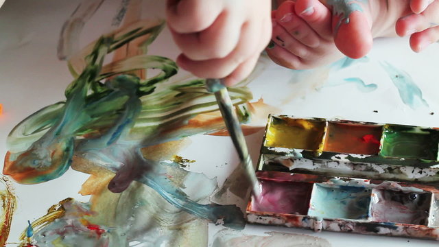 child draws paints closeup