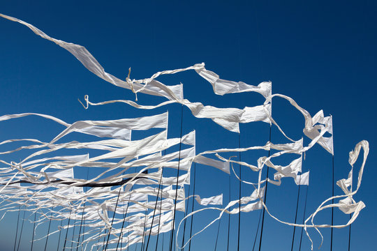 White kite flags in the blue sky