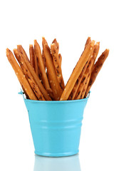 Tasty crispy sticks in blue pail isolated on white