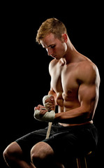 Boxeer wrapping his wrist as he prepares