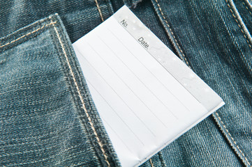 white notebook in jeans pocket