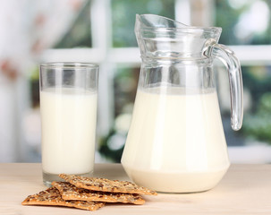 Pitcher and glass of milk with cookies