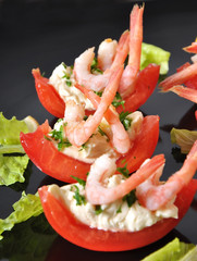 Halves of tomatoes filled with shrimp cocktail 