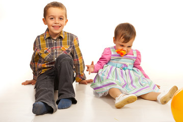 Boy and girl sitting on floor