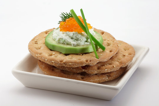 Crispbread with avocado, soft cheese  and salmon caviar