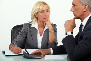 Mature business couple at a desk