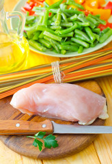 Raw chicken on the wooden board, raw chicken and raw pasta