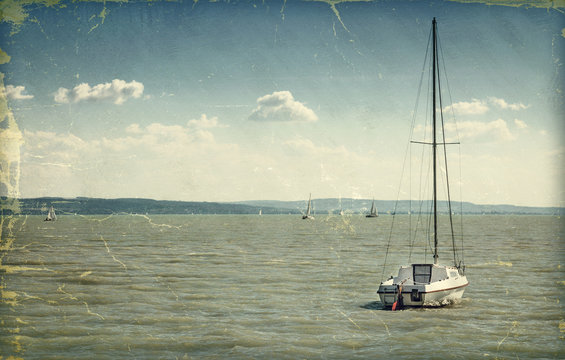 Vintage style photo. Sailing boat on lake
