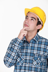 A pensive manual worker.