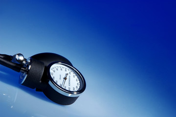 Sphygmomanometer on blue background