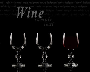 Two empty glasses and one glass of red wine