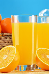 Composition with two glasses of orange juice and fruits