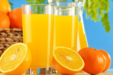 Composition with two glasses of orange juice and fruits