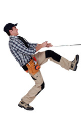 Handyman pulling a rope
