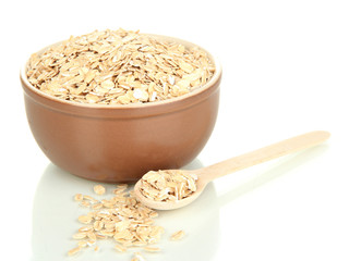 Brown bowl full of oat flakes flakes with wooden spoon isolated
