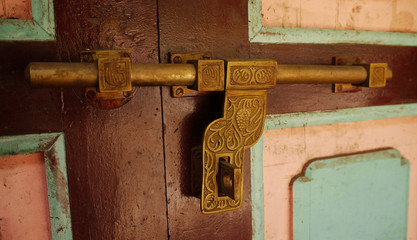 Old brass latch on the door of a house in Nepal.