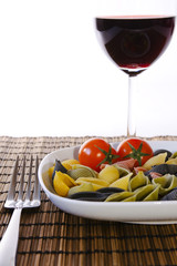 Italian multicolor pasta with wine glass