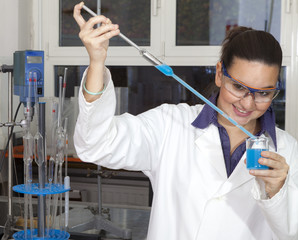 Closeup of a cute female researcher holding test beaker