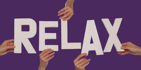 White alphabet lettering spelling RELAX