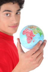 Dark-haired boy with globe