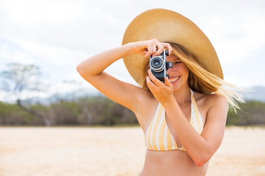 Beautiful Woman at the Beach with Camera